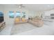 Spacious living room with tile flooring, modern furniture and an open view of the kitchen and dining area at 4432 Seven Canyons Dr, Kissimmee, FL 34746