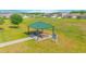 Community pavilion with picnic tables, surrounded by a large grassy field at 4432 Seven Canyons Dr, Kissimmee, FL 34746
