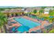 A large pool is fenced in and surrounded by many lounge chairs. A covered area with tables sits to the left of the pool at 4432 Seven Canyons Dr, Kissimmee, FL 34746