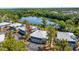 An aerial view of condos overlooking a serene lake surrounded by lush greenery and mature trees at 4465 Ring Neck Rd # C, Orlando, FL 32808