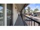 Long screened balcony provides ample room for seating with a view of the parking and building exterior at 4465 Ring Neck Rd # C, Orlando, FL 32808