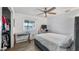 Bright bedroom featuring a ceiling fan, a window, and a cozy workspace with a desk at 4465 Ring Neck Rd # C, Orlando, FL 32808