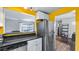 Bright kitchen featuring stainless steel refrigerator, granite countertops, and ample cabinet space at 4465 Ring Neck Rd # C, Orlando, FL 32808