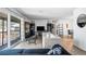 Open-concept living room with balcony access, hardwood floors, and a view into dining area at 4465 Ring Neck Rd # C, Orlando, FL 32808