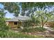 Backyard view of a screened lanai and mature trees at 448 Sundown Trl, Casselberry, FL 32707