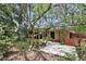 Landscaped backyard view with a patio and mature trees at 448 Sundown Trl, Casselberry, FL 32707
