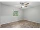 A spacious bedroom with a ceiling fan and light-filled window at 448 Sundown Trl, Casselberry, FL 32707