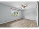 Spacious bedroom with ceiling fan, wood-look flooring and natural light from the window at 448 Sundown Trl, Casselberry, FL 32707