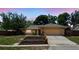 Charming single-story home featuring stone accents, a two-car garage and meticulous landscaping at 448 Sundown Trl, Casselberry, FL 32707