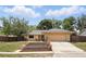 Single-story home boasting stone accents, an attached two-car garage, and manicured landscaping at 448 Sundown Trl, Casselberry, FL 32707