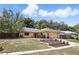 Well-maintained single story house featuring stone accents, mature landscaping and an attached two-car garage at 448 Sundown Trl, Casselberry, FL 32707