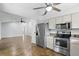 Kitchen with stainless steel appliances and ample counter space adjacent to the living room at 448 Sundown Trl, Casselberry, FL 32707
