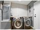 A modern laundry room with stainless steel washer and dryer at 448 Sundown Trl, Casselberry, FL 32707