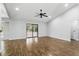 Bright living room featuring hardwood floors, vaulted ceiling, sliding glass doors, recessed lighting, and a ceiling fan at 448 Sundown Trl, Casselberry, FL 32707