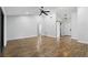 Bright living room features wood-look floors, ceiling fan and sliding barn door at 448 Sundown Trl, Casselberry, FL 32707