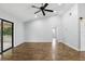 Empty living room features hardwood floors, vaulted ceiling, sliding glass doors and a barn door entrance at 448 Sundown Trl, Casselberry, FL 32707