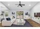 Modern living room featuring hardwood floors, a vaulted ceiling, sliding glass doors and stylish decor at 448 Sundown Trl, Casselberry, FL 32707