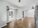 Open and bright living room features wood-look floors and access to outdoor space at 448 Sundown Trl, Casselberry, FL 32707