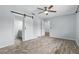 Primary bedroom featuring modern sliding barn doors leading to ensuite bath and closets at 448 Sundown Trl, Casselberry, FL 32707