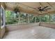 The sunroom with tile floor, large windows and a ceiling fan at 448 Sundown Trl, Casselberry, FL 32707