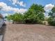 Large backyard with no grass featuring a grassy field and mature trees at 4739 Elkmont Rd, Orlando, FL 32808