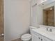 Bright bathroom featuring a white vanity, toilet, and shower with tile surround at 4739 Elkmont Rd, Orlando, FL 32808