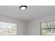 Well-lit bedroom showcasing neutral walls and two windows for natural light at 4739 Elkmont Rd, Orlando, FL 32808