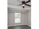 Comfortable bedroom with ceiling fan, window, and neutral gray walls at 4739 Elkmont Rd, Orlando, FL 32808