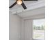 Well-lit bedroom showcasing neutral walls, fan and a window for natural light at 4739 Elkmont Rd, Orlando, FL 32808