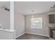 Cozy dining area near the kitchen with modern lighting and a large window at 4739 Elkmont Rd, Orlando, FL 32808