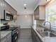 Modern kitchen featuring stainless steel appliances and granite countertops at 4739 Elkmont Rd, Orlando, FL 32808