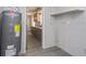 Utility room with water heater, laundry, and an open view to the kitchen at 4739 Elkmont Rd, Orlando, FL 32808