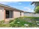 A view of the private backyard with a sliding glass door and a white fence at 504 Delido Way, Kissimmee, FL 34758