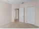 Bright bedroom features neutral walls, carpet, and a closet with bifold doors at 504 Delido Way, Kissimmee, FL 34758