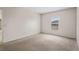 Bright bedroom features carpet, natural light, and neutral color palette at 504 Delido Way, Kissimmee, FL 34758