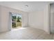 Light-filled living room with tiled floors and sliding glass doors to the outside at 504 Delido Way, Kissimmee, FL 34758