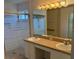 Bathroom vanity with double sinks and a glass enclosed shower at 508 Royal Tree Ln, Oviedo, FL 32765