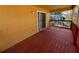 Covered wooden deck features wooden rails and a sliding glass door into the home at 508 Royal Tree Ln, Oviedo, FL 32765