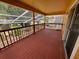 Covered wooden deck features wooden rails and a sliding glass door into the home at 508 Royal Tree Ln, Oviedo, FL 32765