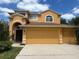 Two-story home with attached garage and manicured lawn under a blue sky at 508 Royal Tree Ln, Oviedo, FL 32765
