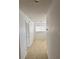 Hallway view with neutral paint, and baseboard trim leading to a windowed room at 508 Royal Tree Ln, Oviedo, FL 32765