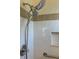 Showerhead with white tiled wall and gray accent stripe in the bathroom at 508 Royal Tree Ln, Oviedo, FL 32765