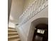 Bright, neutral staircase features white railings and leads to an archway at 508 Royal Tree Ln, Oviedo, FL 32765
