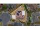 Aerial view of a single-Gathering home featuring a solar panel roof and screened-in patio in a residential neighborhood at 5113 Sage Way, Kissimmee, FL 34758