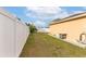 Spacious backyard enclosed with a white fence, providing privacy and room to enjoy at 5113 Sage Way, Kissimmee, FL 34758