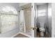 Bathroom featuring a shower with a decorative curtain and toilet at 5113 Sage Way, Kissimmee, FL 34758