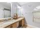 Bathroom featuring double sinks with granite countertops and a decorative mirror at 5113 Sage Way, Kissimmee, FL 34758