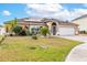Inviting single-story home with manicured lawn, solar panels and a brick-paved driveway at 5113 Sage Way, Kissimmee, FL 34758