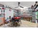 Spacious game room with ceiling fan, laminate flooring, and wall shelving showcasing a car collection at 5113 Sage Way, Kissimmee, FL 34758