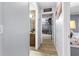 Hallway leading to bathroom and walk-in closet with sports memorabilia at 5113 Sage Way, Kissimmee, FL 34758